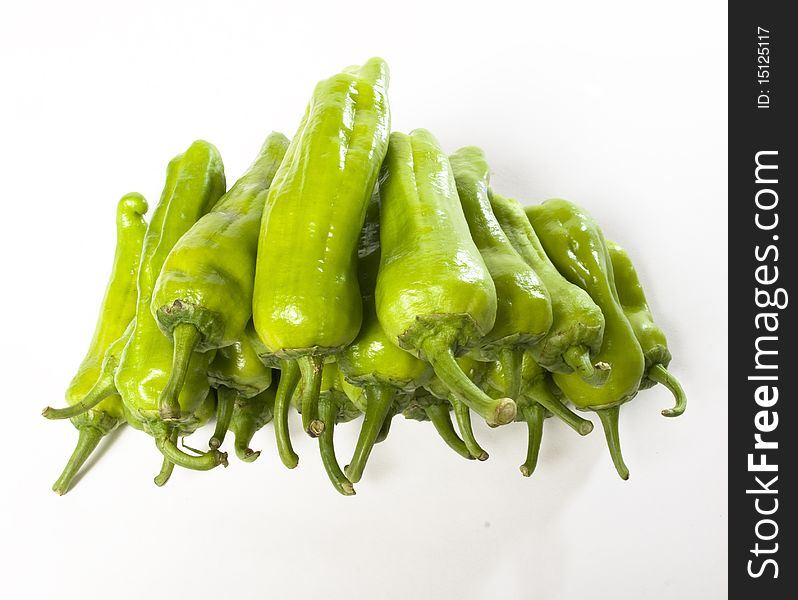 Green peppers over and over on white