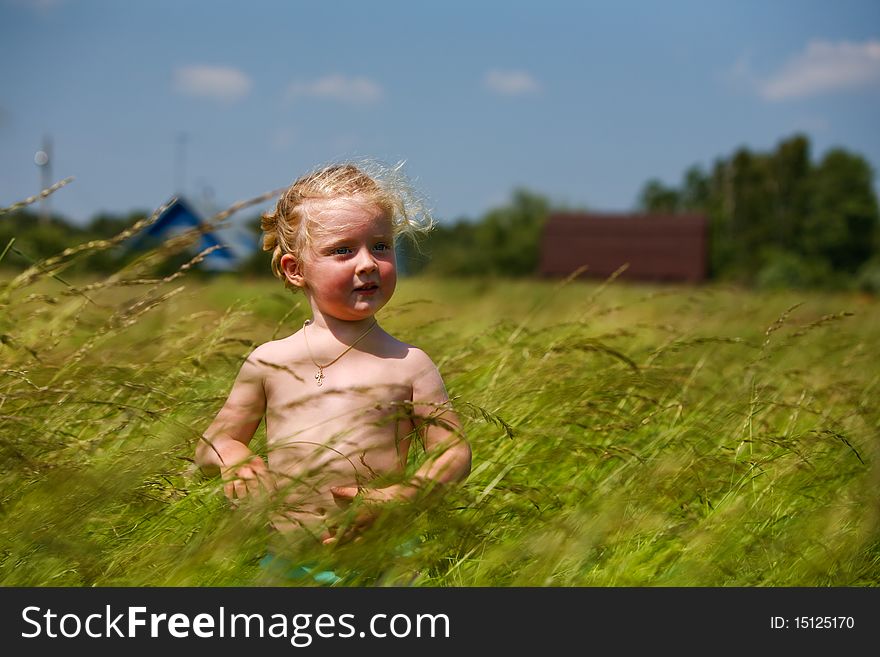 Little girl in the field of countryside