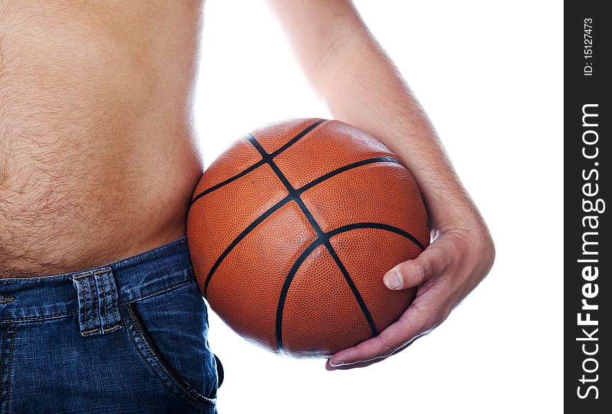 The hand holds a basketball ball resting against a torso. The hand holds a basketball ball resting against a torso