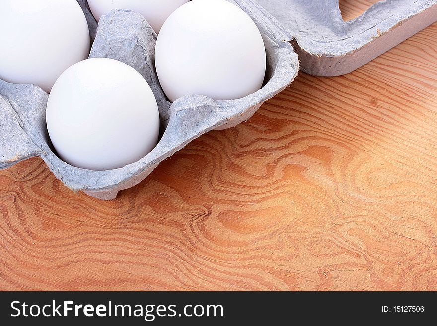 Eggs of white colour are combined in a special tray for transportation and sale.