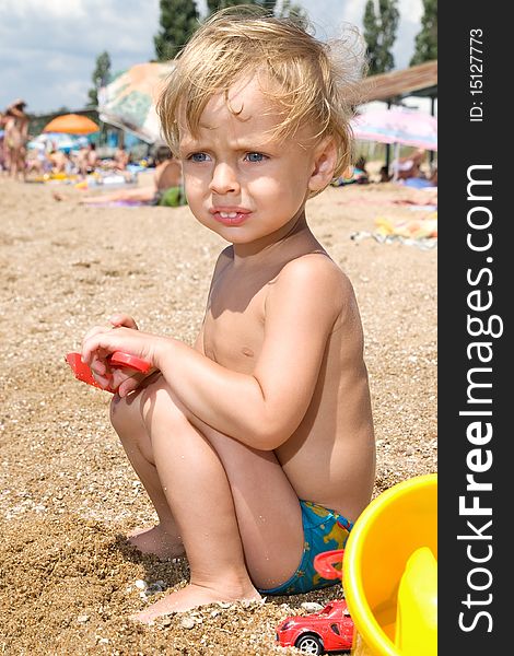 Little Boy Playing At The Seaside At Day