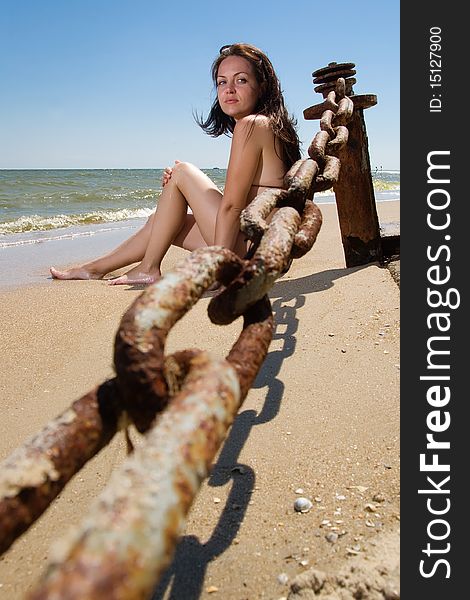 Young woman sitting at the beach