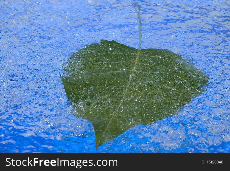 Blue background with raindrop and leaf. Blue background with raindrop and leaf