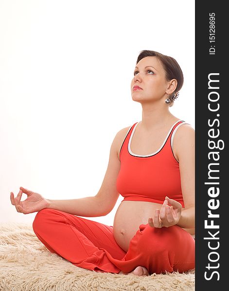 Pregnant woman meditating on a white background