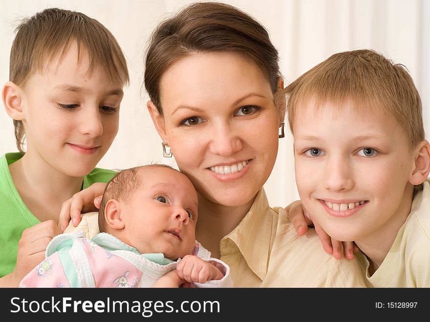 Young mother with three children standing together