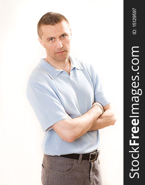 Man in a blue shirt standing on a white