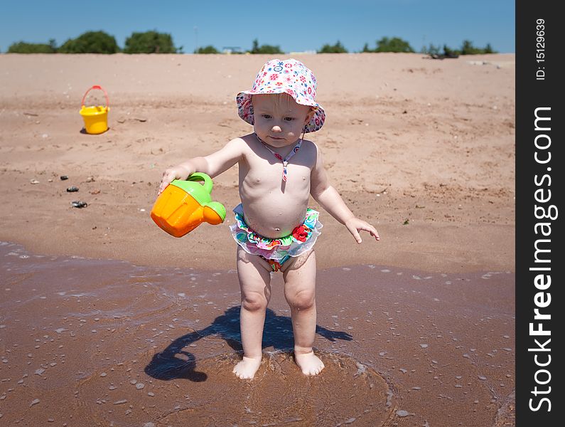 Image of the happy baby playing on the beach