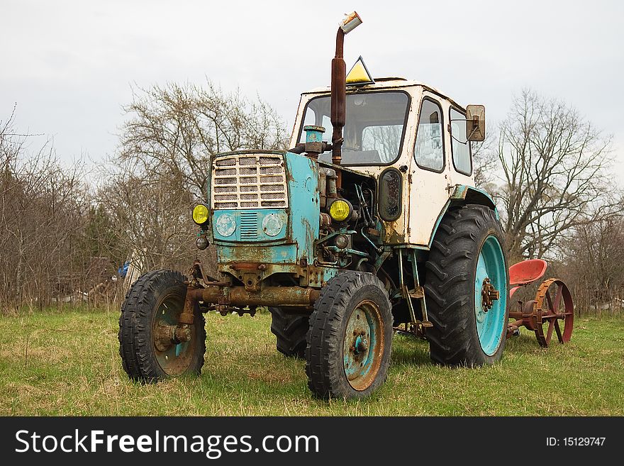 Old wheeled tractor in countryside