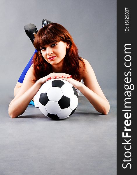 Lying young girl on floor with a soccer ball. Lying young girl on floor with a soccer ball