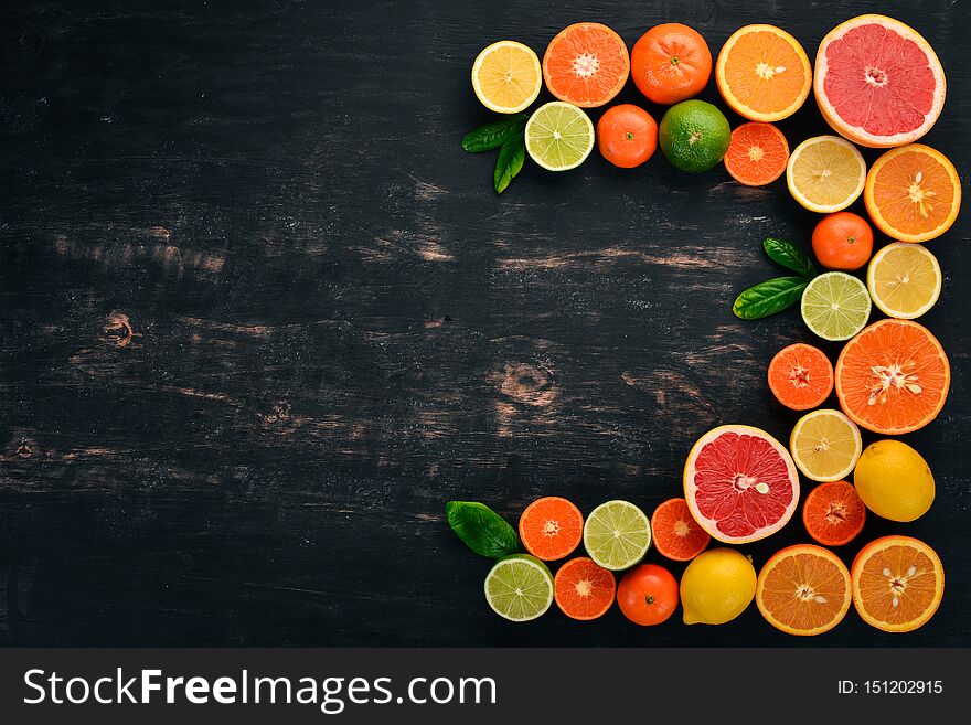 A set of citrus fruit. Orange, tangerine, grapefruit, lemon. On a wooden background. Top view. Copy space