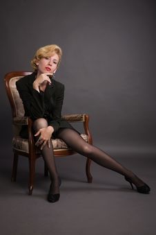 Woman In A Business Suit Sits In An Armchair Stock Photography