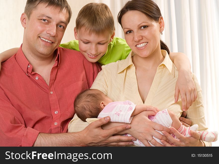 Happy smiling parents with their two children