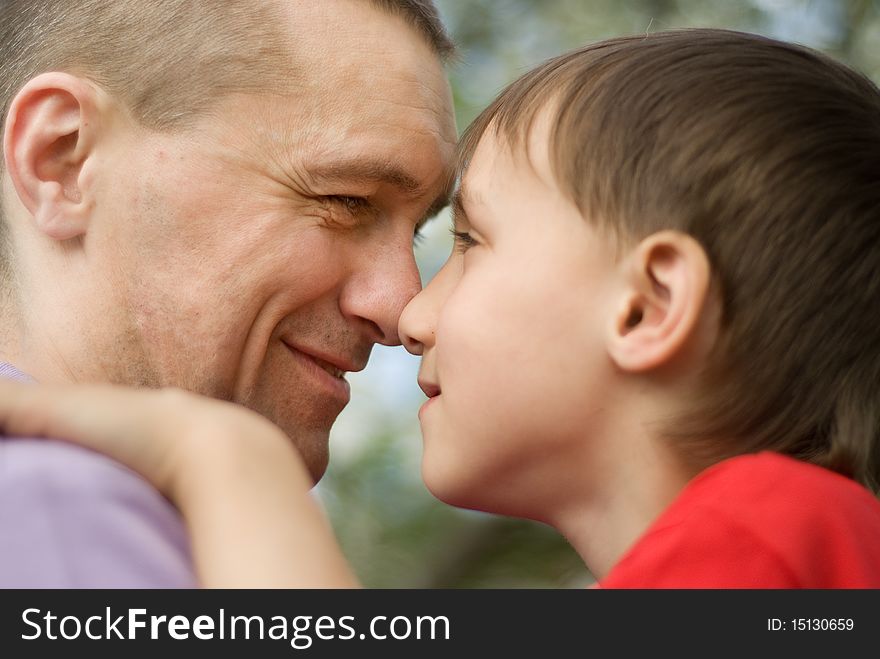 Happy father with his son in a park