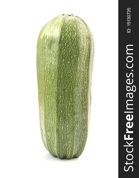 Single green zucchini isolated on white