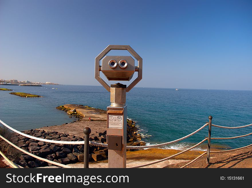 Large coin operated binocular looking at the Atlantic Ocean. Coast of Tenerife Island, Canaries, Spain.