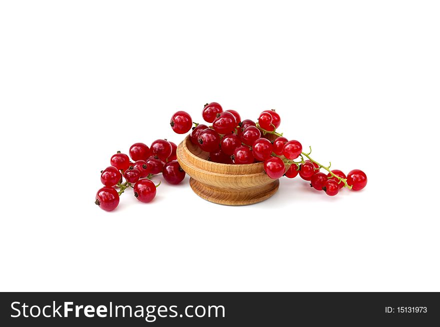 Ripe fresh red currants in a wooden bowl on a white background