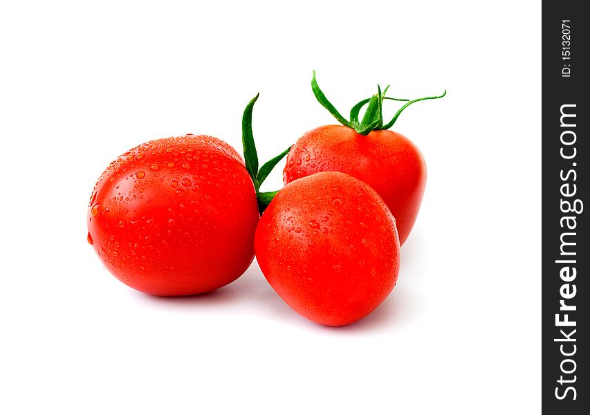 Three ripe red tomatoes with drops of water on a white background. Three ripe red tomatoes with drops of water on a white background