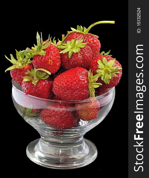 Juicy strawberry glass bowl isolated on black background