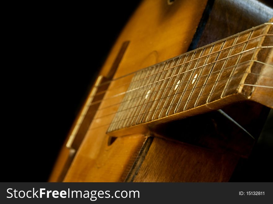 Classical guitar on black background