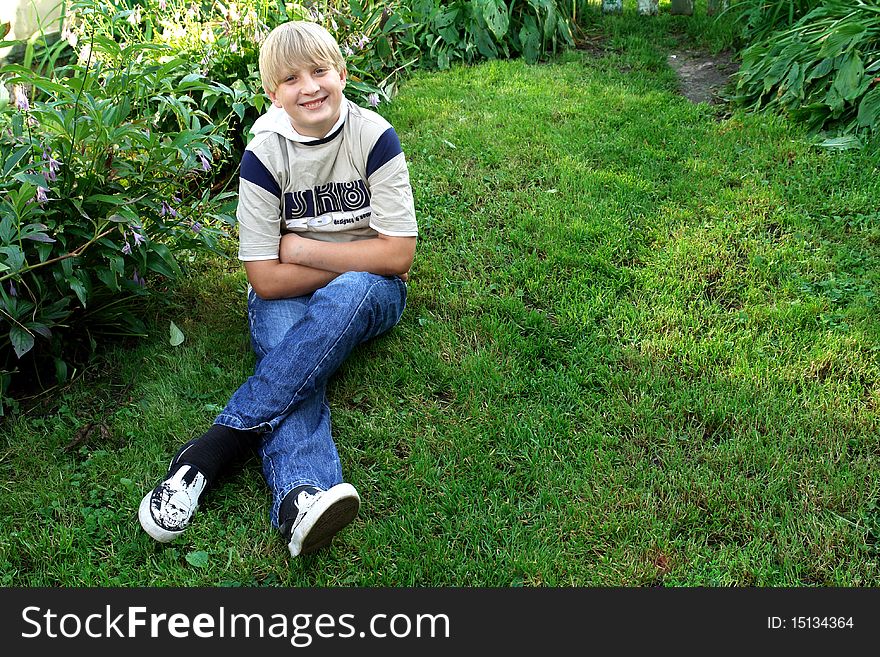 Portrait of a boy on a green lawn. Portrait of a boy on a green lawn
