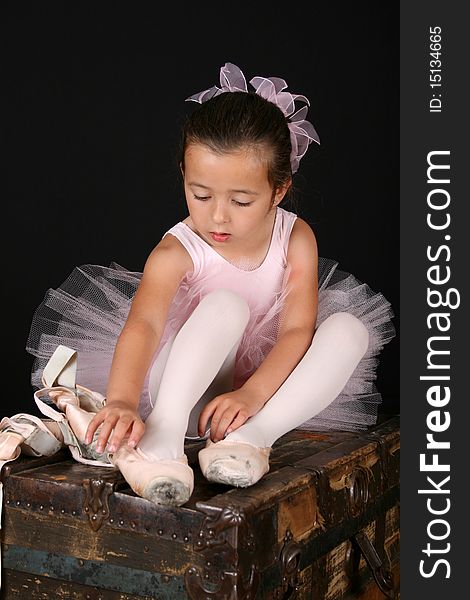 Cute little ballet girl trying on pointe shoes