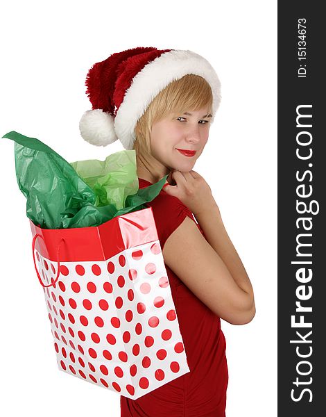 Beautiful young female wearing a christmas hat holding a gift bag. Beautiful young female wearing a christmas hat holding a gift bag