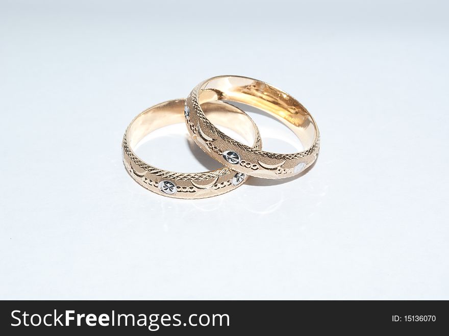 Gold wedding rings with identical designs. Gold wedding rings with identical designs.