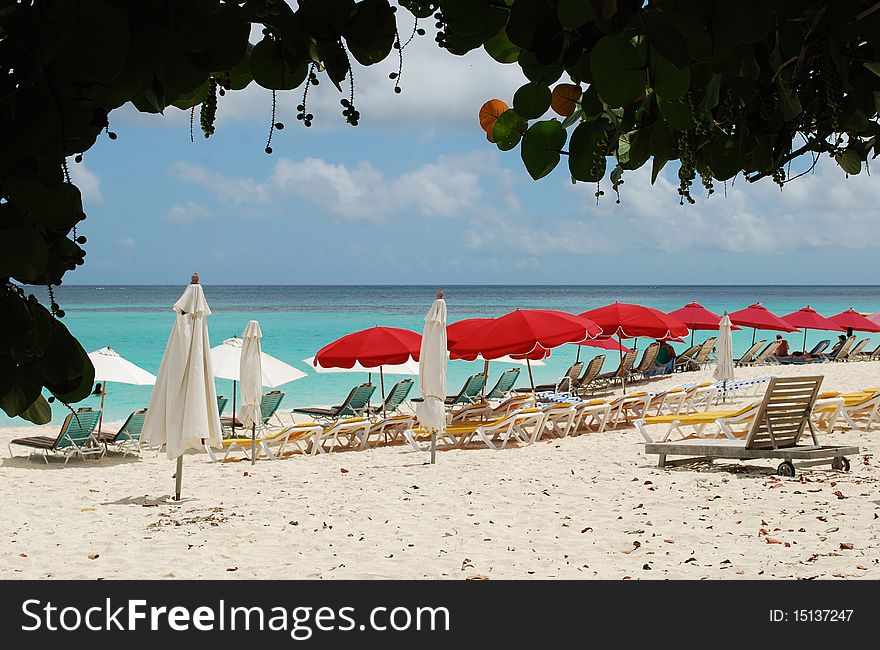 Beach chairs and umbrellas at sandy beach, Saint-Martin Island. Beach chairs and umbrellas at sandy beach, Saint-Martin Island