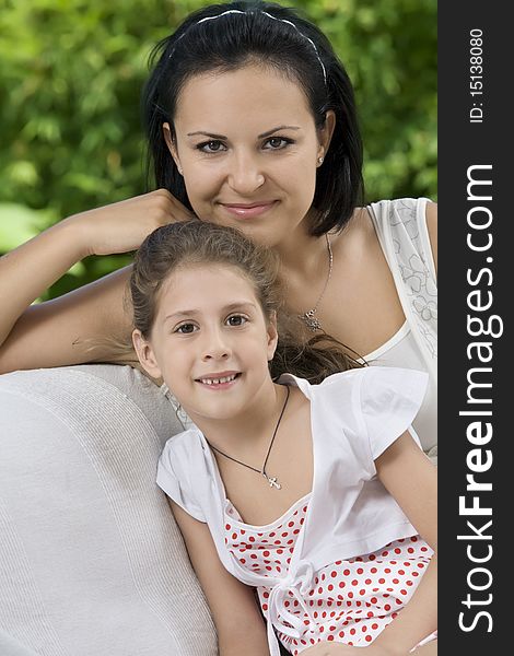 Portrait of happy mother with daughter having good time in summer environment. Portrait of happy mother with daughter having good time in summer environment