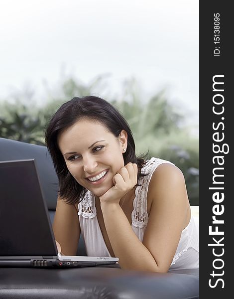 Portrait of woman with laptop in summer environment. Portrait of woman with laptop in summer environment