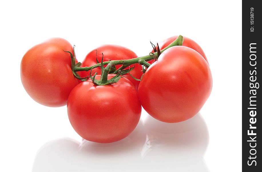 Tomatoes with a branch, on a white background, it is isolated. Tomatoes with a branch, on a white background, it is isolated.