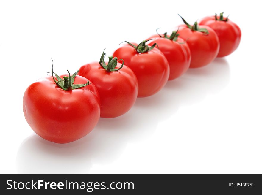 Red tomatoes on a white background, it is isolated. Red tomatoes on a white background, it is isolated.