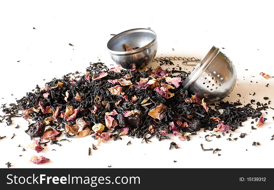 Mineral deposit of tea on a white background, alongside sieve