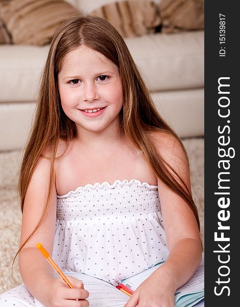 Cute little girl doing her homework, close-up shot. Cute little girl doing her homework, close-up shot