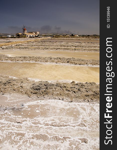 Old windmill and salt marshes at Infersa Salt Pans, Marsala, Sicily, Italy