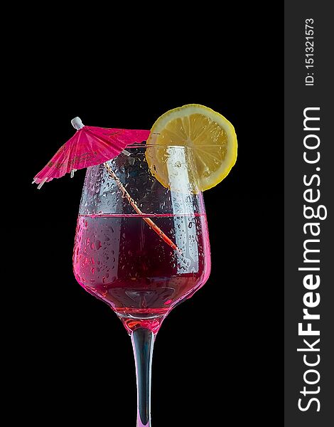 Cocktail Isolated In Black Background With Lemon Slice And Umbrella