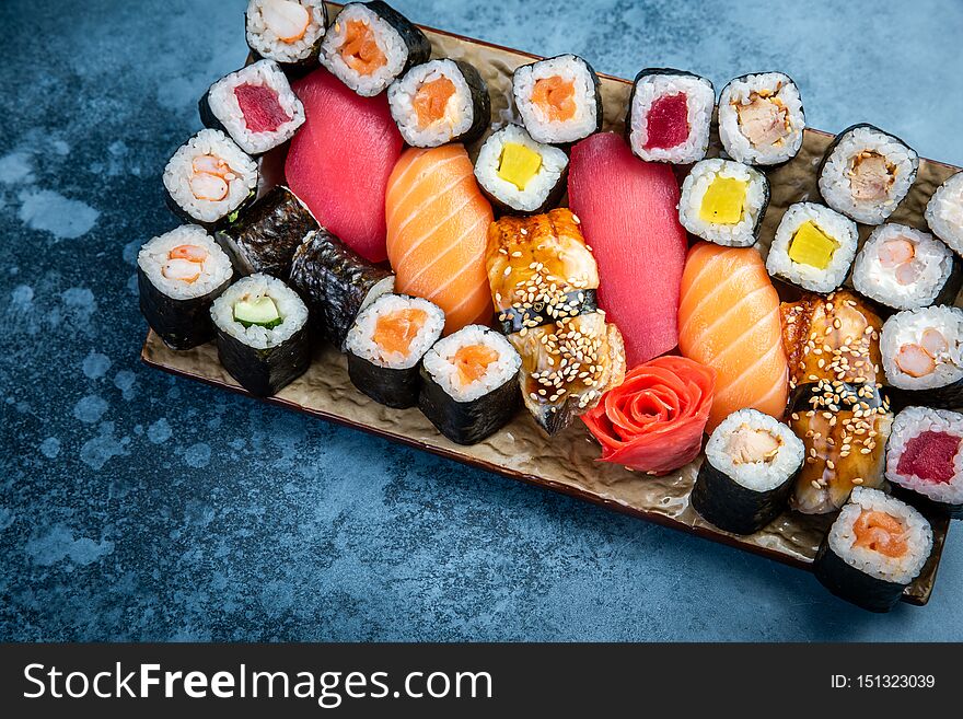 Top view of traditional delicious Japanese seafood served on wooden board on dark marble background. Top view of traditional delicious Japanese seafood served on wooden board on dark marble background