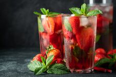 Fresh Lemonade With Ice, Mint And Strawberry On Top In Glass On Black Table Background, Copy Space. Cold Summer Drink Royalty Free Stock Photography