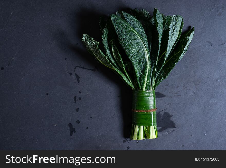 Bunch of fresh Italian kale on dark background. Bunch of fresh Italian kale on dark background
