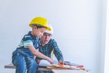 Builder Father Teaching His Son To Read The Construction Plan Paper Royalty Free Stock Photography