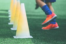 Feet With Soccer Boots Training On Training Cone On Soccer Ground Royalty Free Stock Photography Feet With Soccer Boots Training On Training Cone On Soccer Ground Royalty Free Stock Photography
