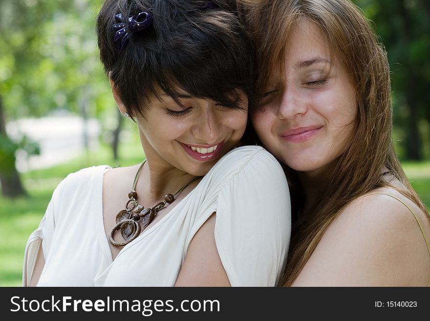 Couple of young girls embracing with cheerful smile. Couple of young girls embracing with cheerful smile