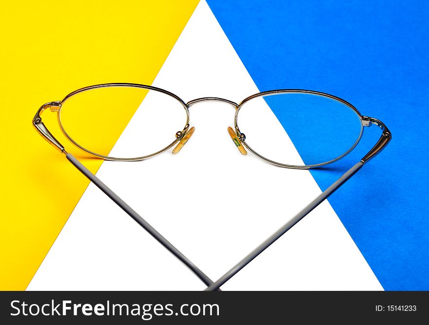 Glasses for eyes on blue and yellow background
