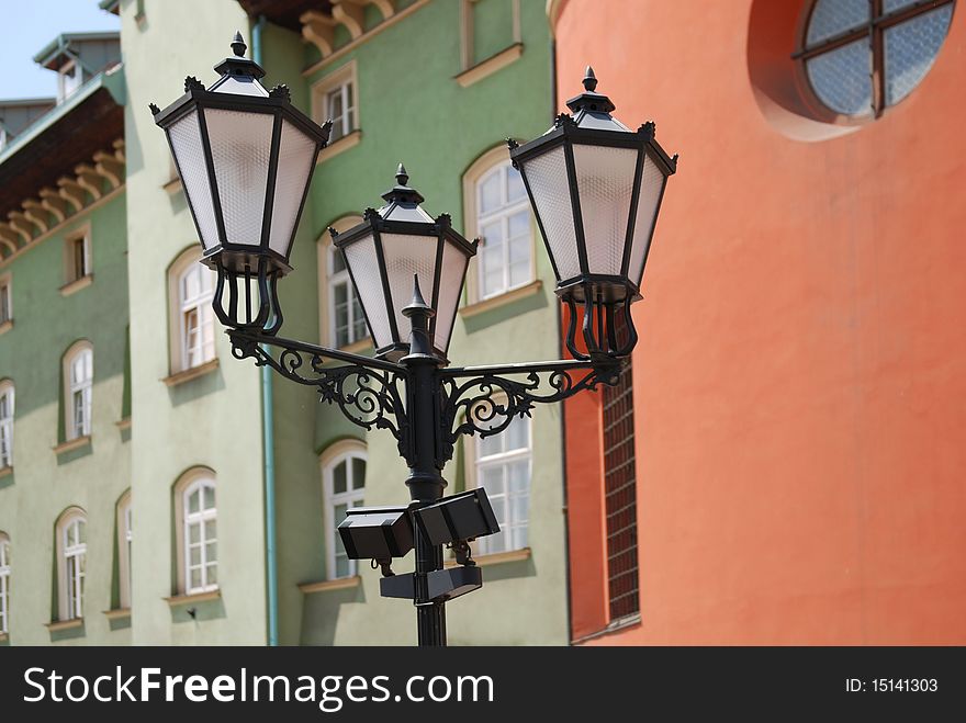 Street lamp in front of the wall of green brick