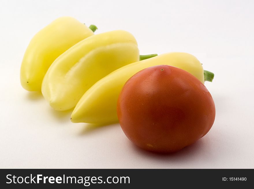 Fresh tomato and sweet peppers on a white background. Fresh tomato and sweet peppers on a white background