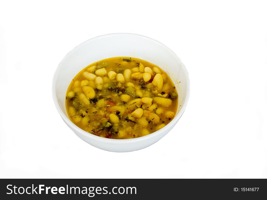 White beans stewed with vegetables in ceramic dish in isolated over white. White beans stewed with vegetables in ceramic dish in isolated over white