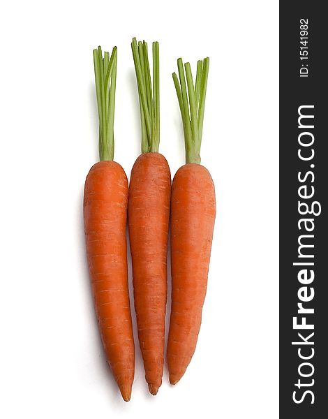 Three carrots on white with a path