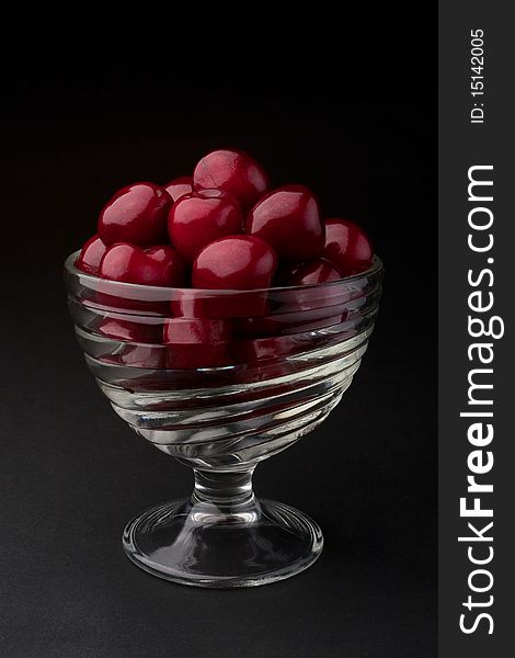 Cherries in a bowl on a black