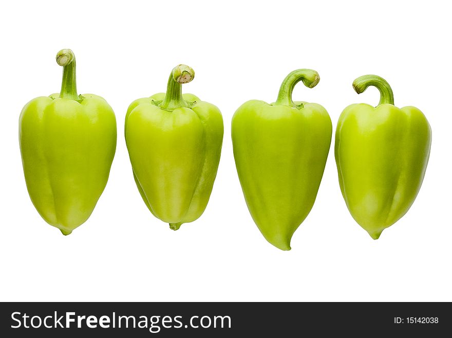 Four green bell peppers isolated with a path