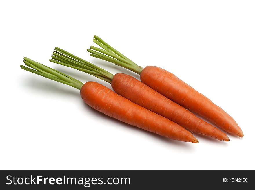 Three carrots on a white isolated with a path